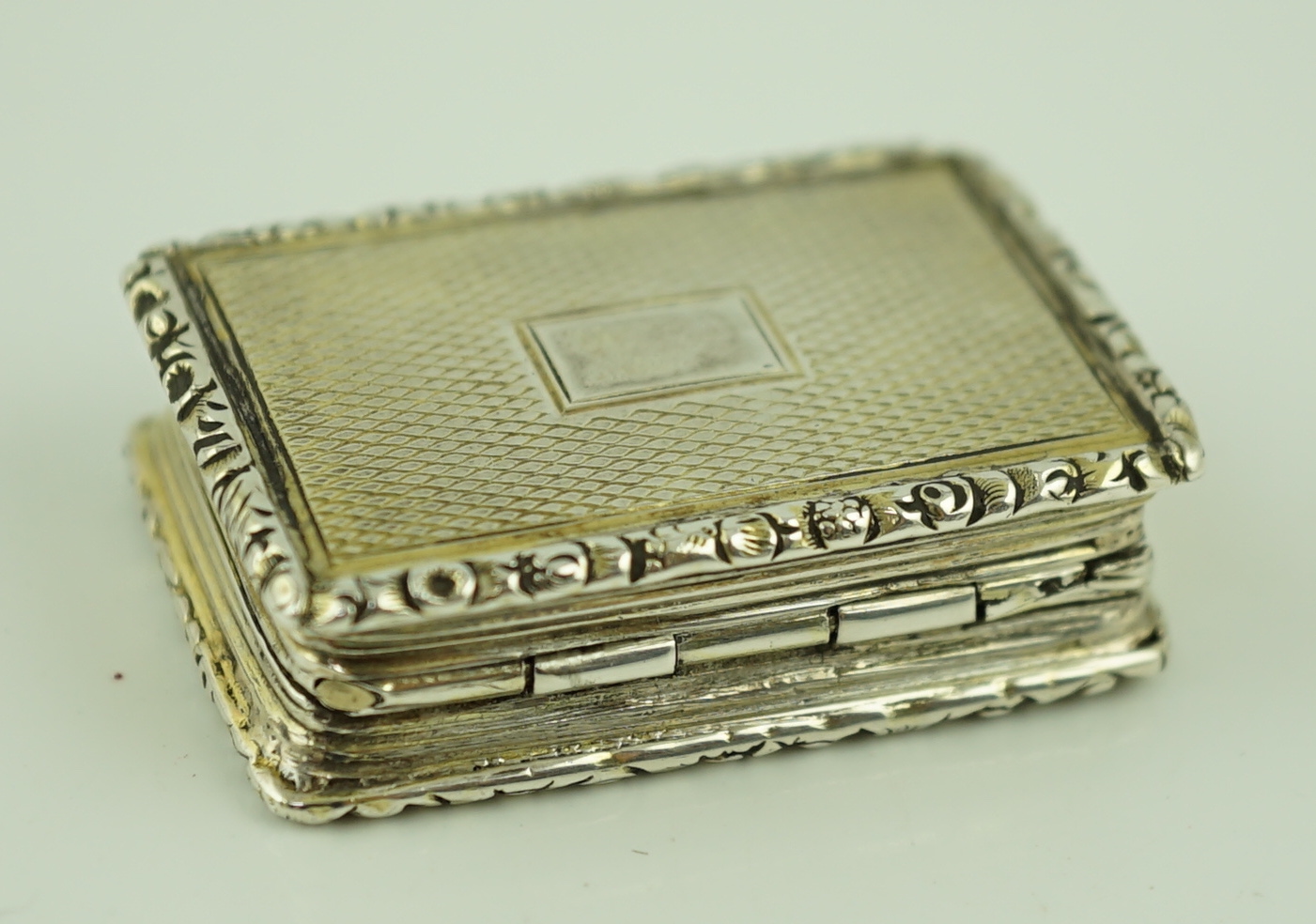 A William IV engine turned silver gilt rectangular vinaigrette, by Joseph Wilmore